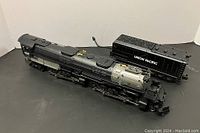 O scale die-cast Union Pacific Big Boy locomotive and tender on black surface.