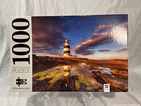 Box of Mindbogglers 1000 piece jigsaw puzzle featuring lighthouse image