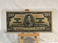 Front side of the 1937 $20 Canadian banknote showing King George VI portrait and serial number.