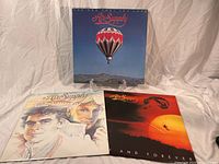 Three vinyl Air Supply albums displayed on a white cloth backdrop.