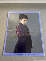 Full autographed picture showing Michelle Gomez in character and gold signature
