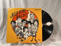 Front cover of the Just For Laughs comedy album with vinyl partially pulled out.