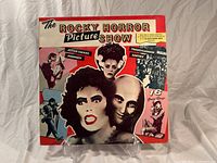 Front cover of The Rocky Horror Picture Show soundtrack LP sleeve, colorful character collage and text.