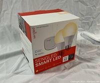 Photo of sealed Sengled Smart LED kit box showing images of 2 LED light bulbs and the hub device.