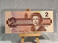 Front of uncirculated 1986 Canadian two dollar bill showing Queen Elizabeth II