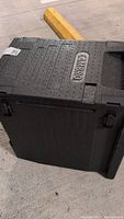 Black Cambro cooler shown from top-down with visible Cambro logo and locking latches.