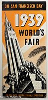 Front cover of folded 1939 World's Fair program/map showing iconic architecture and palm trees in orange, white, and black.