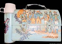 Photo showing the metal lunch box with Revolutionary War soldier artwork and attached thermos displaying eagle design and pink cup lid.