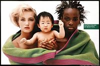 Framed 1990s United Colors of Benetton advertising poster showing diverse group wrapped in green blanket, created by Oliviero Toscani.