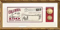 Framed set showing commemorative stamp with 150th anniversary artwork of Columbia, California, two medallions on red background, and decorative gold frame.