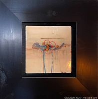 Framed ceramic tile showing the full artwork with abstract circular and linear design on a cream background.