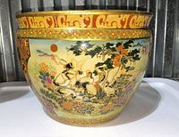 Front view showing hand-painted cranes, flowers, trees, and sun scene with decorative gold and multi-color border on top