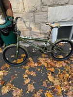 Full side view of the Specialized 415 BMX bike with green frame and knobby tires.