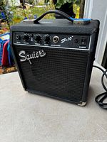 Front view of Squier SP-10 guitar amplifier showing controls and logo