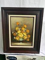 Front view of the framed canvas painting showing yellow rose bouquet and wooden frame.