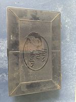 Closed black plastic tackle box with Bass Pro Shops embossed logo on lid