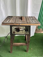 Full view of Ohio Forge 10" Table Saw showing metal tabletop with blade slot and control panel below.