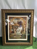 Front view of the Victorian style framed picture showing the young woman seated with flowers, in a golden ornate frame.