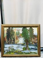 Frontal photo showing the landscape painting inside a wooden frame against a curtain backdrop.