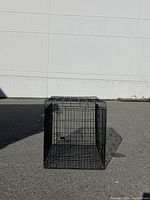 Front angle view of the foldable metal pet crate showing its rectangular structure and wire bars.