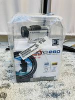 Midland XTC 280 action video camera in original sealed plastic packaging, showing front and branding details.