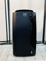 Front view showing glossy black finish and digital control panel.