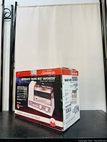 Box of Sunbeam Dura Vap warm mist vaporizer model DV-1, showing front and side with product photos and details in English and French. Box has wear and tape but item inside is like new.