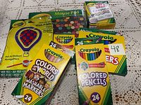 Various Crayola art supplies including colored pencils, washable markers, crayons, paint sets, and a mouse pad.