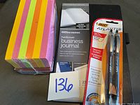 Photo of multi-colored sticky notes (3x3 inches), Office Depot hardcover business journal (271 sheets), and Bic Atlantis ballpoint pens (2-pack)