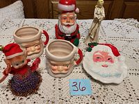 Full view of vintage Christmas lot on crocheted tablecloth showing all items