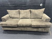 Front view of the 70-inch sofa showing three cushions and fabric upholstery.