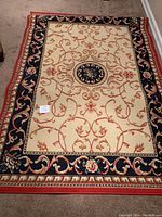 Full view of the area rug showing the full design and color scheme including central medallion and borders