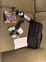 Vision VT-50 telescope, tripod, carrying pouch, lenses, and instruction manual laid out on green fabric.