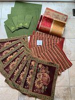 All placemats and cutlery holders arranged together showing various fall and green themed patterns