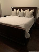 King size bed frame assembled with mattress and linens (not included)