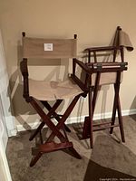 Pair of director's chairs side by side showing overall view and frame structure.