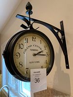 Front view of double-sided clock showing 'Grand Central Terminal New York' text and black metal mounting bracket.