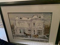 Framed Walter Campbell print showing large white classical mansion in winter with horse and carriage in front.