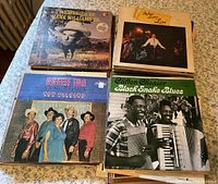 Four vinyl albums including Memories of Hank Williams Sr, Mel Lewis Live, Queen Ida and The Bon Temps Zydeco Band, Clifton Chenier Black Snake Blues.