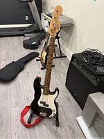 Full view of bass guitar on Apex stand with strap