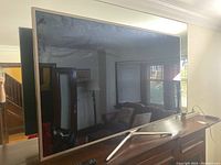 Front view of Samsung 60-inch LED TV on V-shaped stand showing screen and bezel