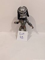 Predator bobblehead figure with close view of helmet and armored body showing slight damage