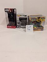 Photo showing all three items side by side with a lot number card: Star Wars Kylo Ren bobble-head, Fallout Pop! figure, and Tonka toy truck.