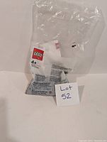 Front view of sealed plastic LEGO bag with visible LEGO logo and lot number card.