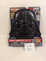 Front view of the black Darth Vader Pig Carry Case in original packaging with branding and warning labels visible.