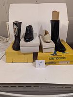 Lot of various vintage shoes and boots with their original boxes, showing wear from storage.