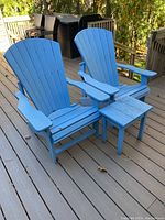 Two light blue Adirondack chairs on deck with matching side table