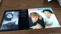Photo shows both vinyl album 'Make It Big' and 12-inch single 'Careless Whisper' with covers visible on wooden surface.