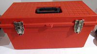 Closed red plastic toolbox with metal latches and black handle