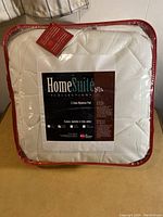 Photo of the HomeSuite 3 Zone Mattress Pad in its original packaging, showing brand and product name.